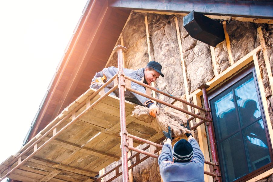 workers thermally insulating house facade denver co